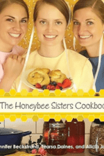 Three sisters smiling and holding plate of food